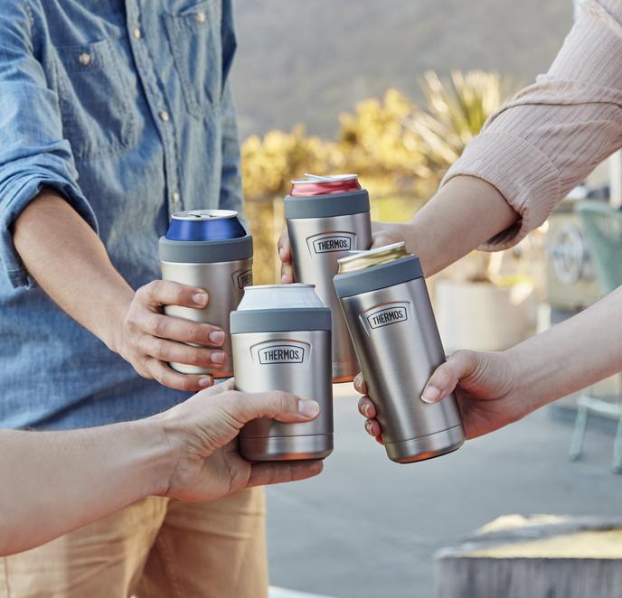 People holding various Thermos insulated cups outdoors.