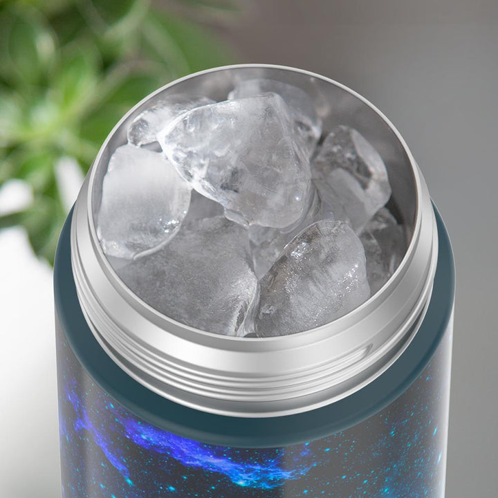 16-ounce Galaxy Teal Funtainer water bottle, opened and full of ice.